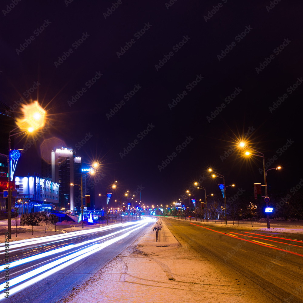 Fototapeta premium Winter night road in city, snow background