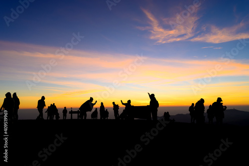 Silhouette group of tourist traveling to see sunrise over phu lom lo mountain