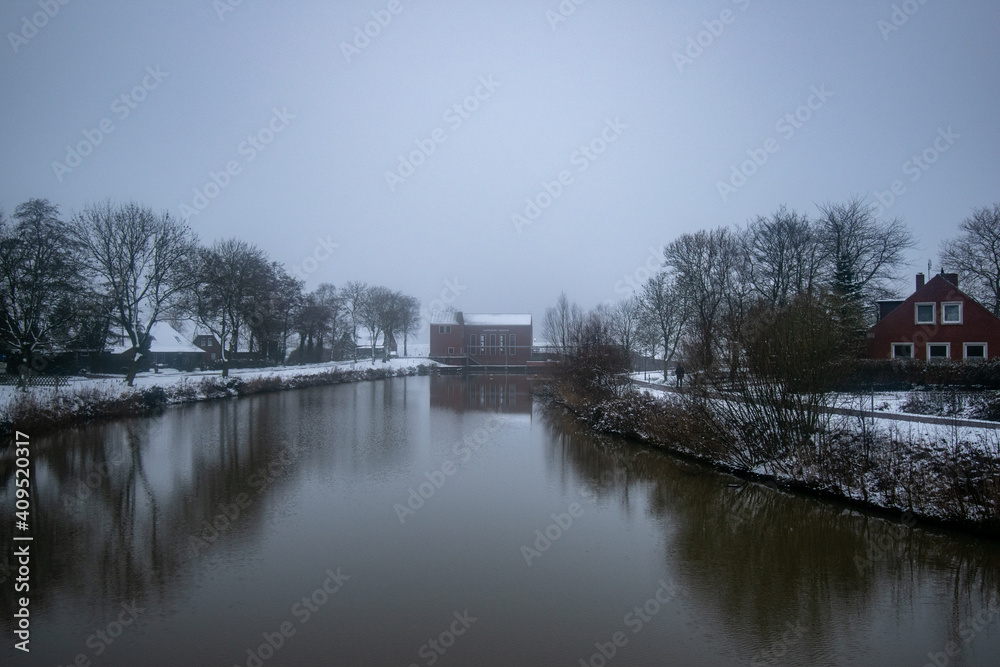 Greetsiel pumping station in the fog in winter Greetsiel pumping station in the fog in winter