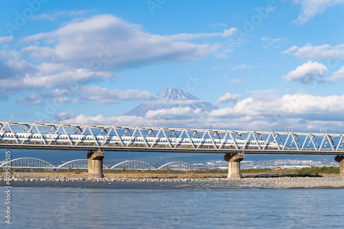 Footage of Bullet train or Shinkansen in Japanese passing through mount Fuji at Fujikawa bridge in Shizuoka, Japan