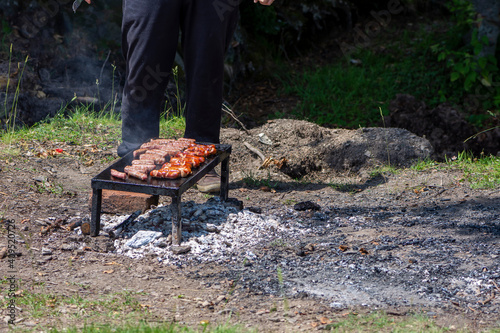 Grilling meat on bbq stone grill in nature photo