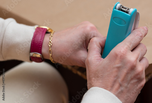 Close up of a woman's hands making handicrafts with a stapler