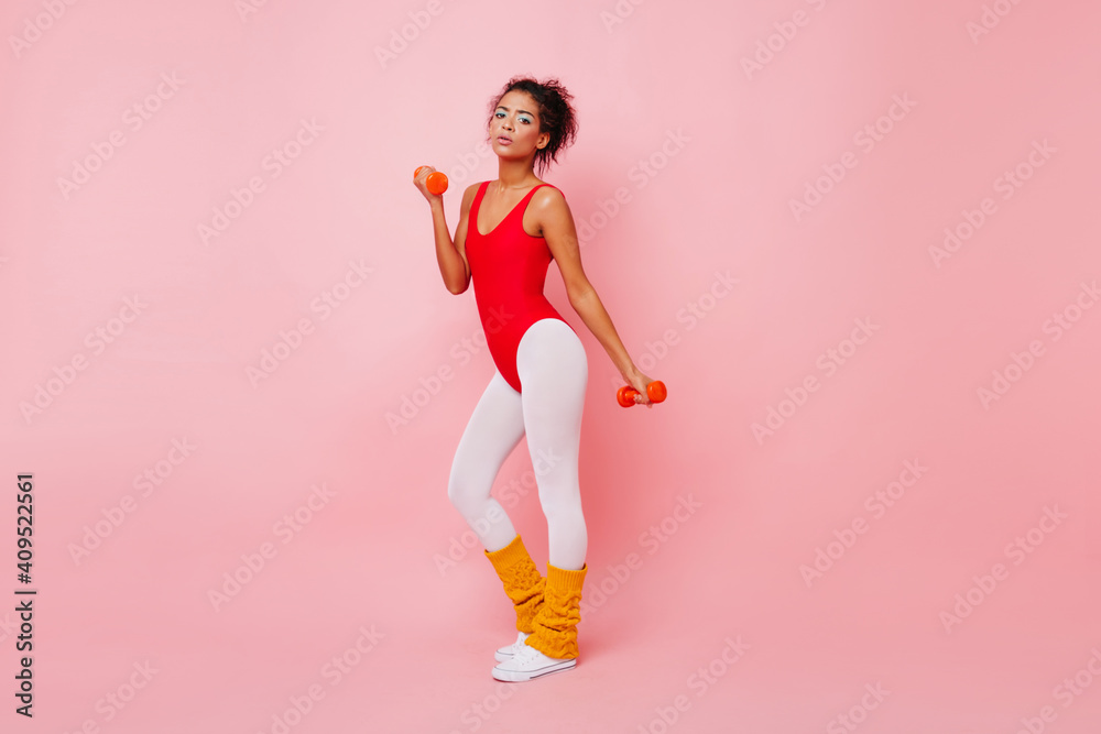 Full length view of shapely african woman in aerobics bodysuit