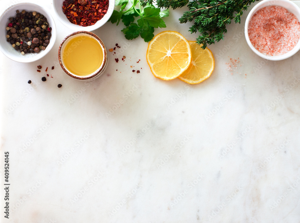 Food stone background with ingredients-greens, sea salt, peppers, olive oil and lemon Food stone background with ingredients-greens, sea salt, peppers, olive oil and lemon