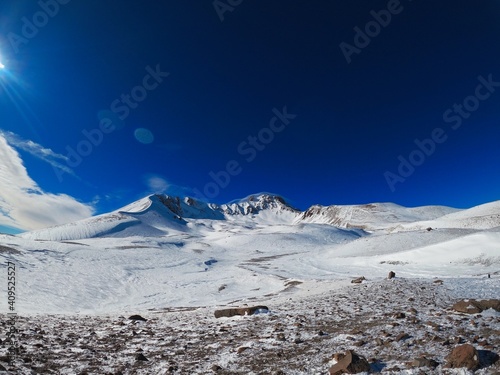 The summit of the sleeping volcano in Erciyas Turkey in winter. Sunny bright day in the mountains. Clear blue sky over the ski slope. photo