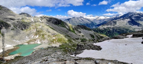 Panoramic view of the Friesenberghaus hut and a turquoise lake in Zillertal Alps in June, Austria