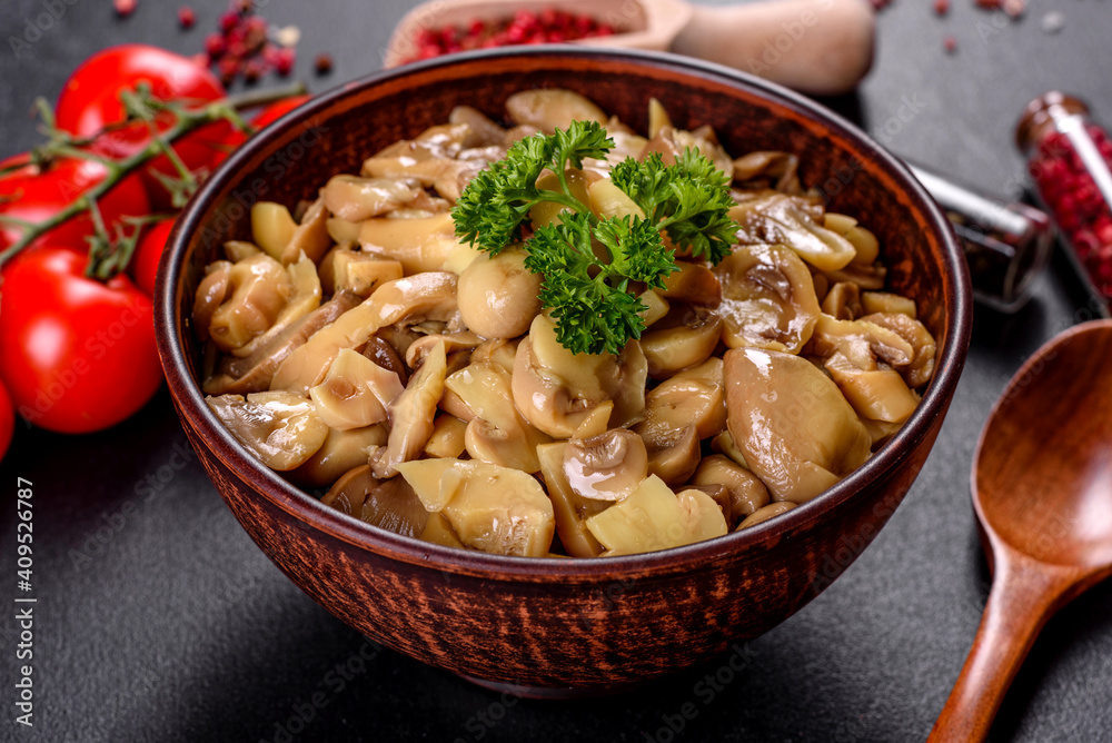 Fresh delicious spicy canned mushrooms with spices and herbs in ceramic dishes Fresh delicious spicy canned mushrooms with spices and herbs in ceramic dishes