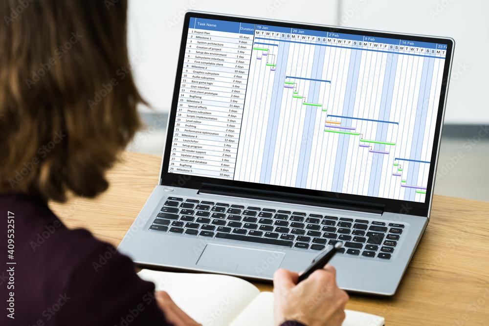 Businesswoman Working On Gantt Chart Using Computer Businesswoman Working On Gantt Chart Using Computer