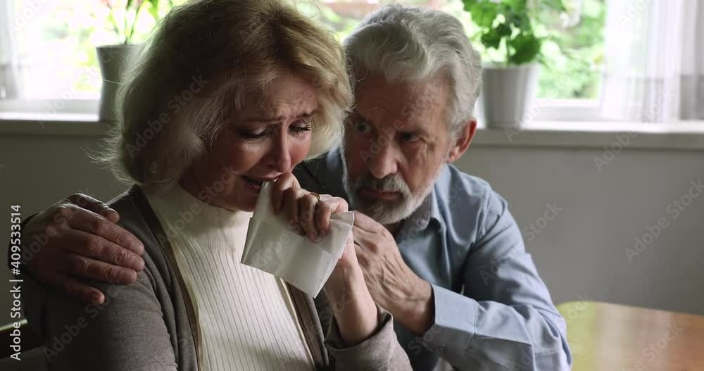 Guilty older mature hoary husband sincerely apologizing to crying wife, making peace after conflict or quarrel, affectionate man cuddling soothing stressed middle aged woman, reconciliation concept. Guilty older mature hoary husband sincerely apologizing to crying wife, making peace after conflict or quarrel, affectionate man cuddling soothing stressed middle aged woman, reconciliation concept.