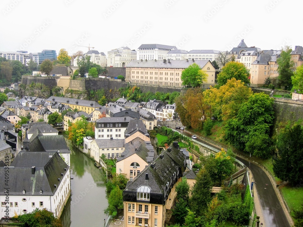 View of Luxembourg City with Alzette River passing through the Grund Quarter and Abbey de Neumunster. Typical houses with black slate roofs in Luxembourg City View of Luxembourg City with Alzette River passing through the Grund Quarter and Abbey de Neumunster. Typical houses with black slate roofs in Luxembourg City