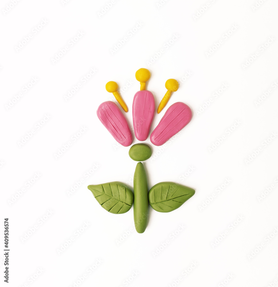 cute colorful flower made of plasticine on a white background. diy made of plasticine