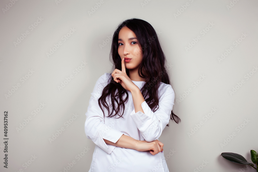young asian woman doctor in white uniform gesturing positive on gray background, lifestyle healthcare people concept young asian woman doctor in white uniform gesturing positive on gray background, lifestyle healthcare people concept