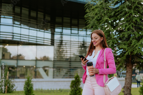 Beautiful woman using mobile phone on the street