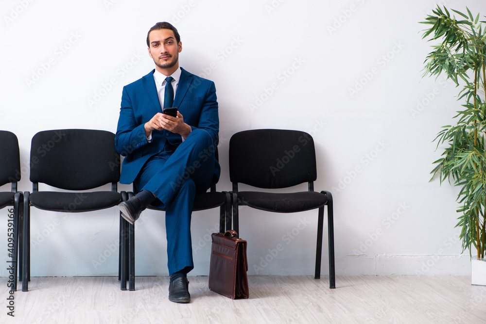 Young businessman waiting for an interview at hall Young businessman waiting for an interview at hall