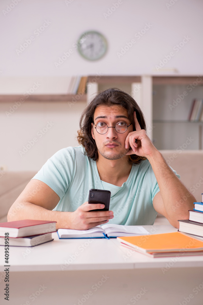 Young male student preparing for exams at home Young male student preparing for exams at home