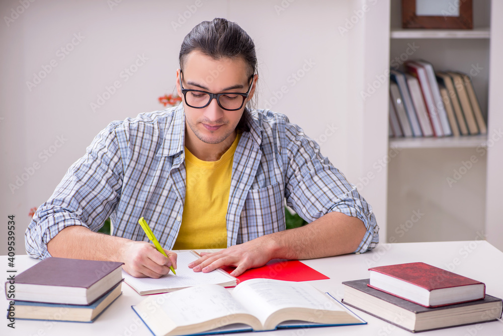 Young male student preparing for exam at home Young male student preparing for exam at home