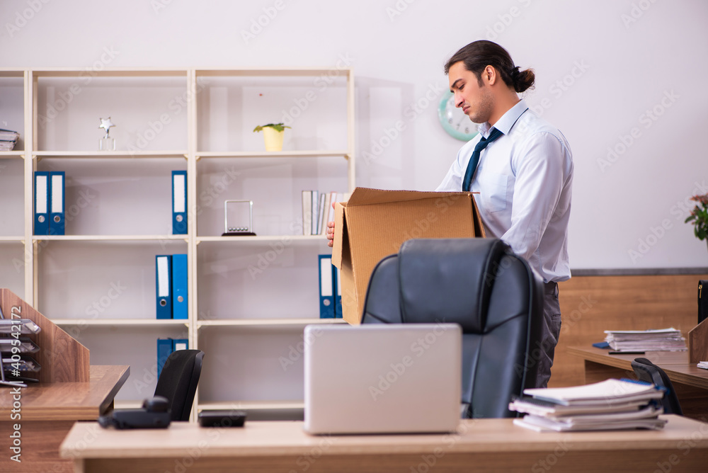 Young male employee being dismissed from his work Young male employee being dismissed from his work