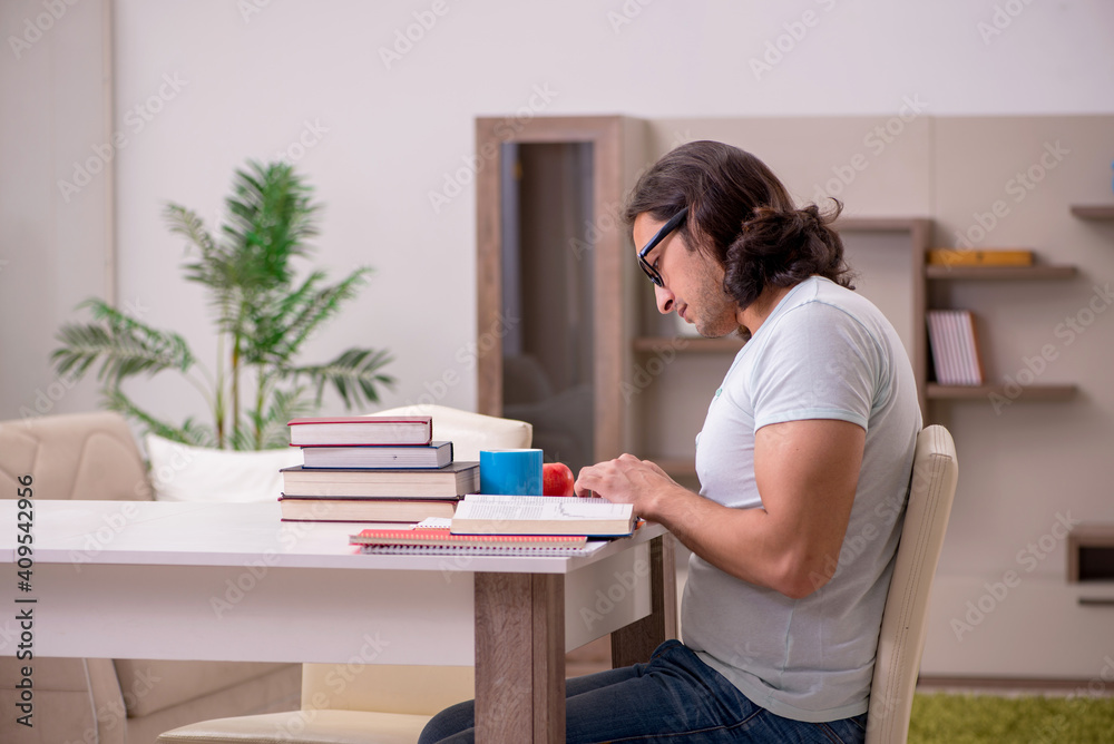 Young male student preparing for exams at home Young male student preparing for exams at home