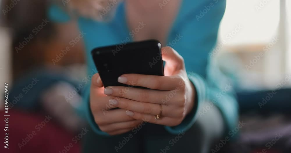 Female hands using smartphone at home Female hands using smartphone at home