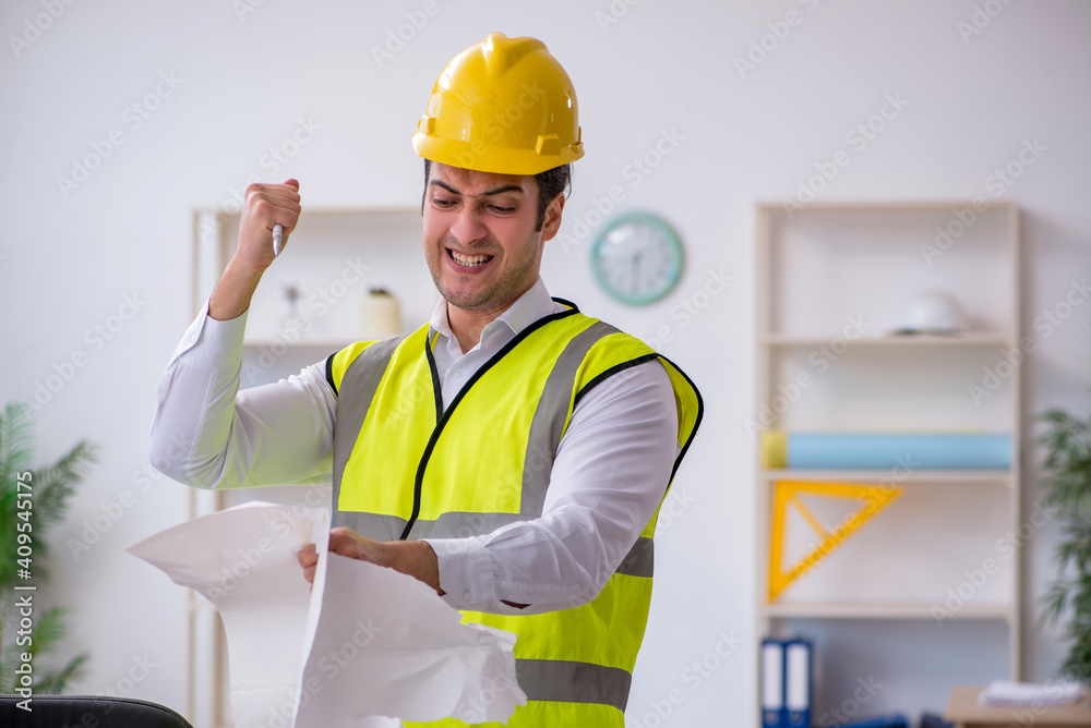 Young male architect working in the office Young male architect working in the office