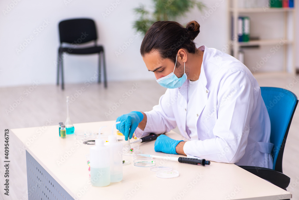Young male chemist working in the lab during pandemic Young male chemist working in the lab during pandemic