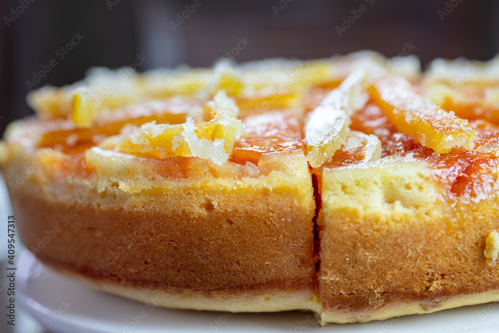 Orange Upside Down Cake with Candied Orange and Lemon Rind on a Plate