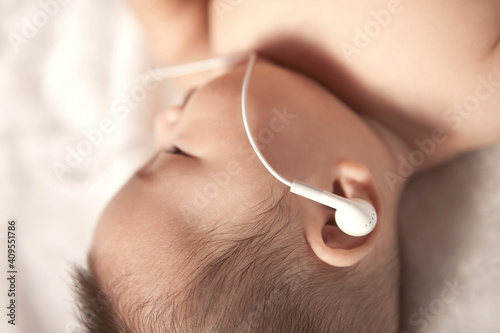 Baby with a earbud