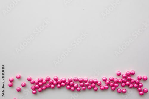 round pink candies on a white background