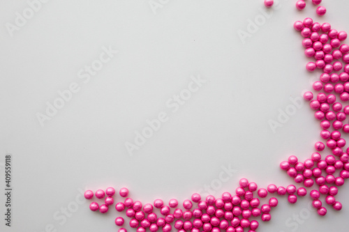 round pink candies on a white background