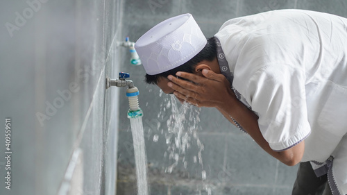 A portrait of an asian muslim ablution at mosque before pray photo