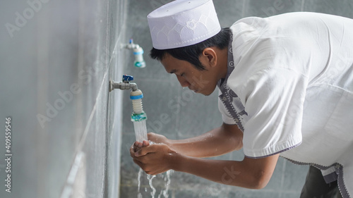 A portrait of an asian muslim ablution at mosque before pray