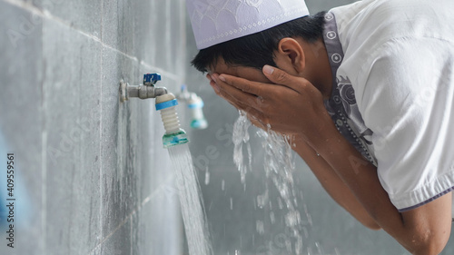 A portrait of an asian muslim ablution at mosque before pray photo