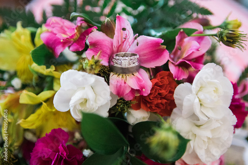 Pink, red, white, yellow flowers with wedding or engagement ring