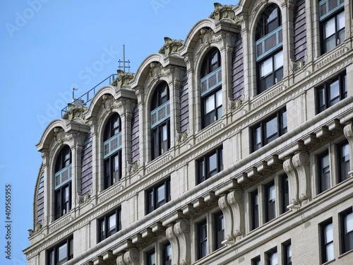 Close-up view of baroque ornamentation at the top of an old luxury apartment building © Spiroview Inc.