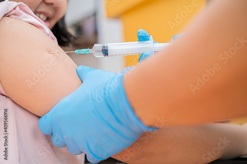 Little girl receiving chickenpox vaccination in clinic  closeup.