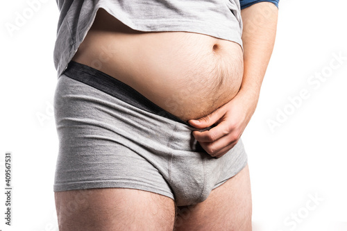 The belly of a fat man on an isolated background photo