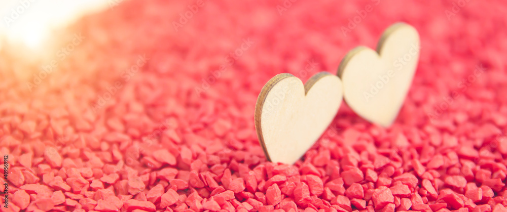 Fototapeta premium Close-up two hearts for love symbol on a red sand background. Concept the day of love 14 February happy valentine's day.