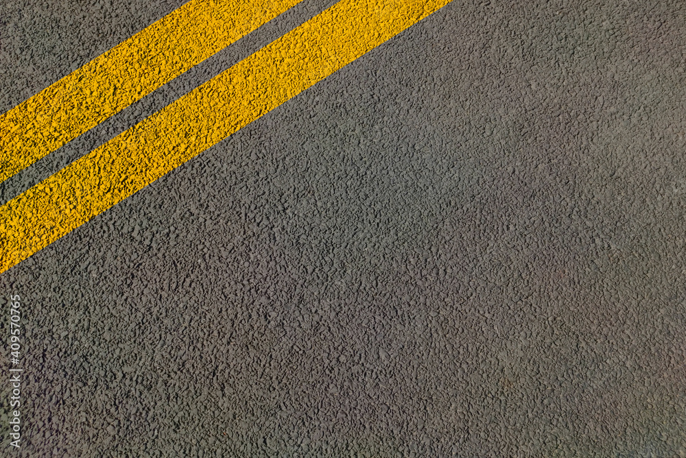 Double yellow lines on road painted for directional movement in lanes without overtaking . Stock