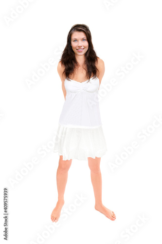 Full leght portrait of a beautiful young woman wearing a short summer skirt, tank top and sunglasses, isolated on white studio background photo