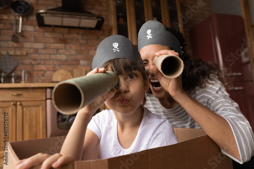 Foto Head shot portrait happy mother and little daughter playing pirates, looking at