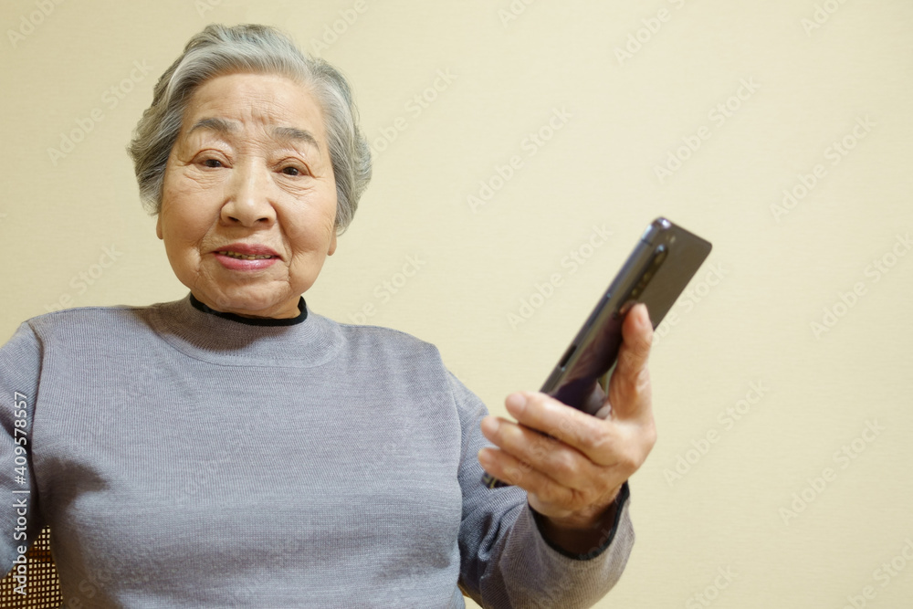 スマートホンを持った笑顔のおばあちゃん スマートホンを持った笑顔のおばあちゃん