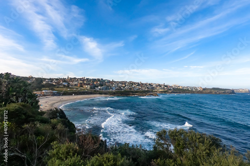 Fototapeta Naklejka Na Ścianę i Meble -  Sydney, beach, ocean, blue water, famous, sand, building, rocks, clouds, bush, green, grass