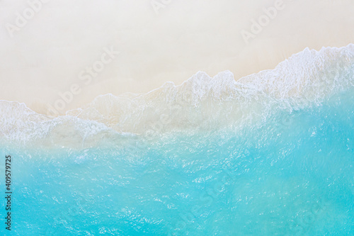Relaxing aerial beach scene, summer vacation holiday template banner. Waves surf with amazing blue ocean lagoon, sea shore, coastline. Perfect aerial drone top view. Peaceful bright beach, seaside