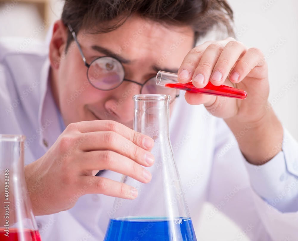 Mad crazy scientist doctor doing experiments in a laboratory Mad crazy scientist doctor doing experiments in a laboratory