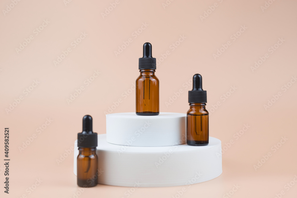 Brown glass bottles with serum, essential oil or other cosmetic product. Natural organic cosmetic packaging, skin care concept.