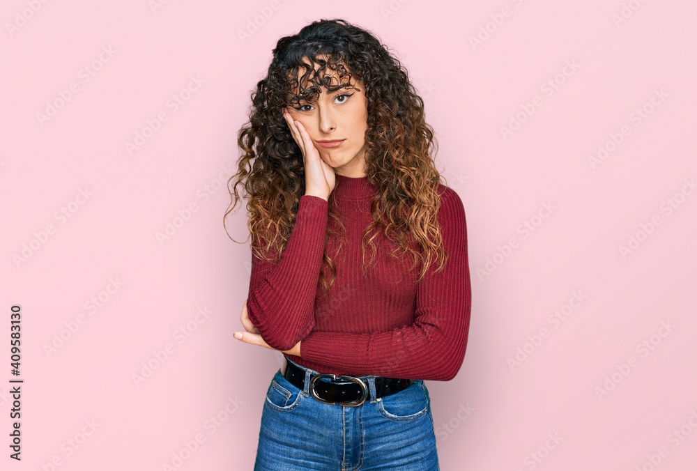 Young hispanic girl wearing casual clothes thinking looking tired and bored with depression problems with crossed arms. Young hispanic girl wearing casual clothes thinking looking tired and bored with depression problems with crossed arms.