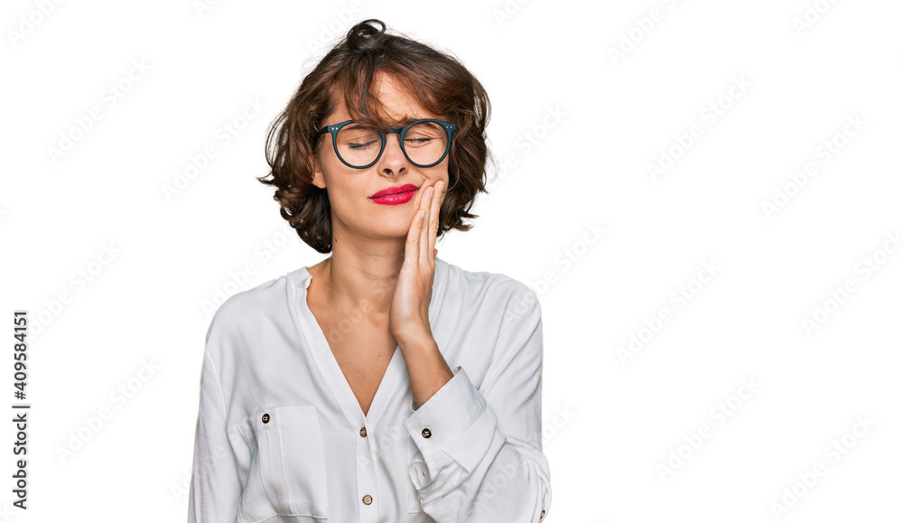 Young hispanic woman wearing business style and glasses touching mouth with hand with painful expression because of toothache or dental illness on teeth. dentist