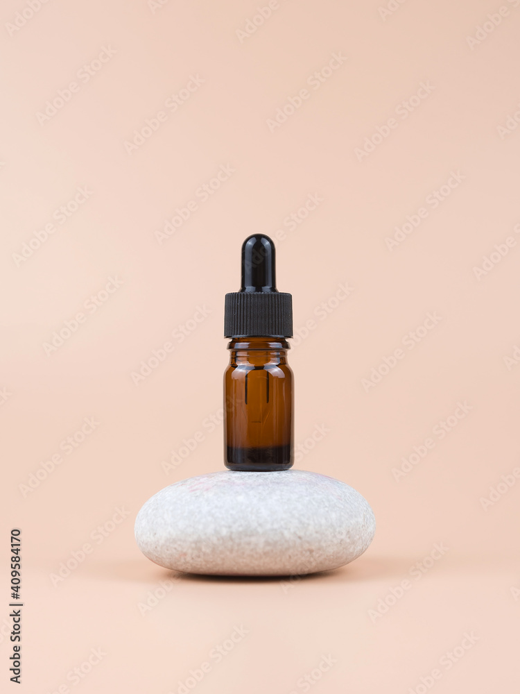 Brown glass bottle with serum, essential oil or other cosmetic product. Skin care concept.
