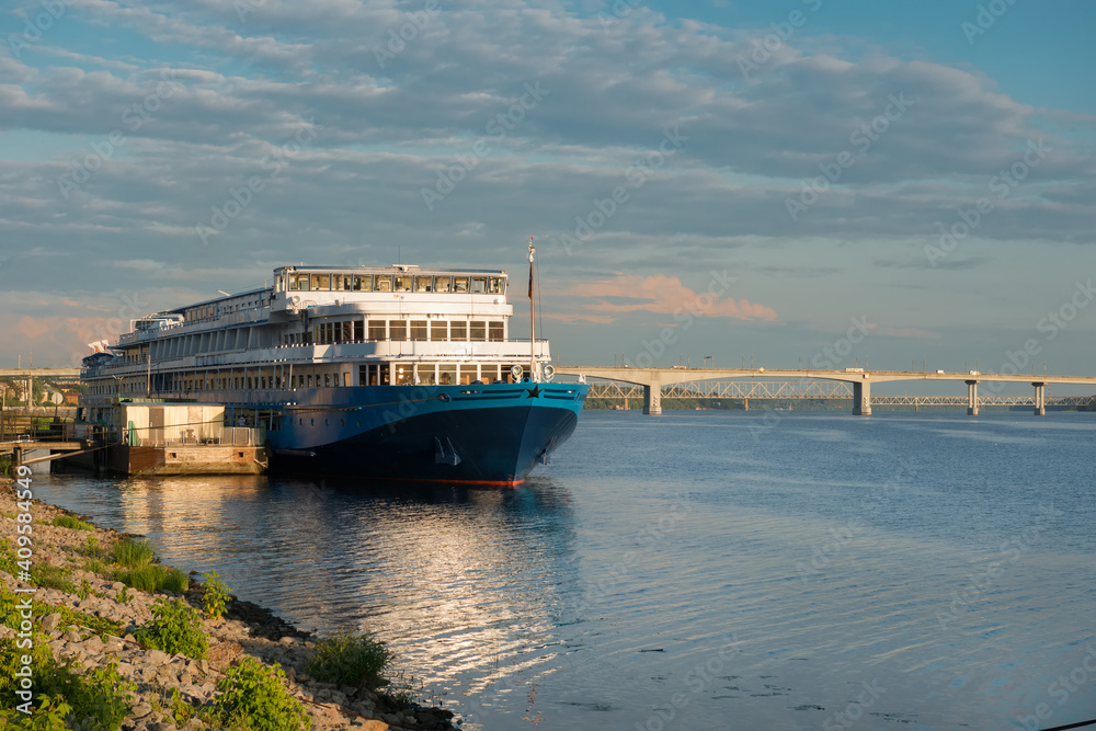 Cruise ship at the pier on the Volga river in the city of Kostroma on a summer evening