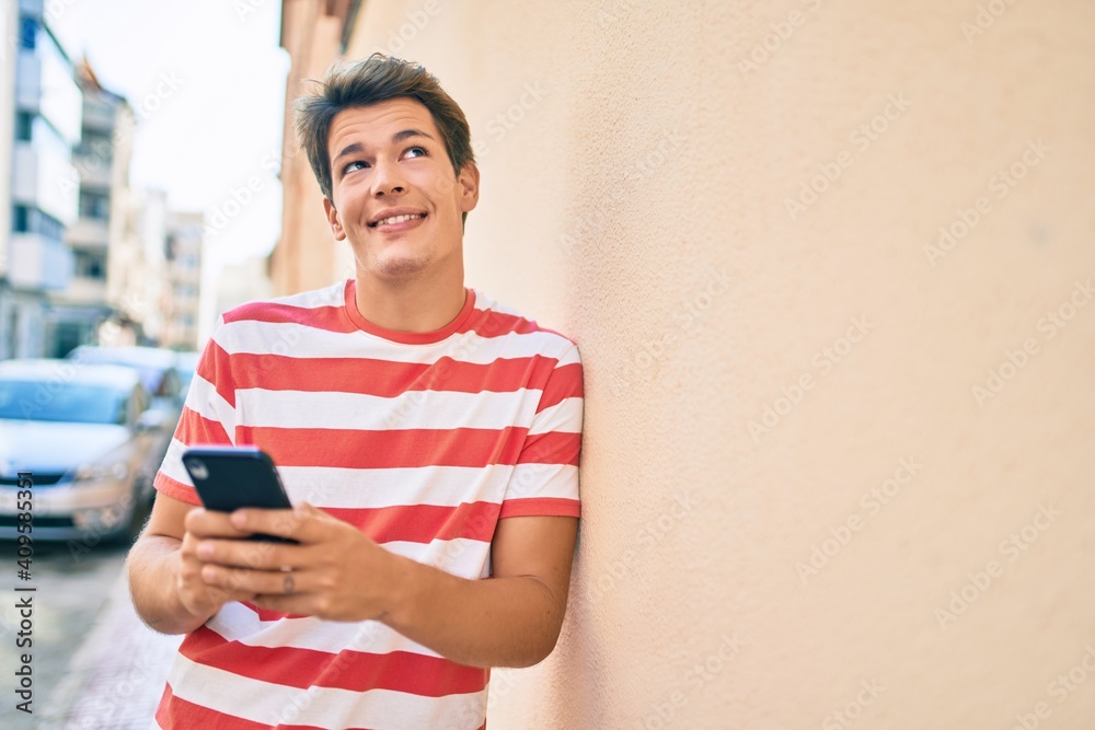Young caucasian man smiling happy using smartphone at the city. Young caucasian man smiling happy using smartphone at the city.